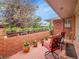 Charming brick patio with a row of potted flowers and comfortable seating, creating a tranquil outdoor space at 3481 S Race St, Englewood, CO 80113