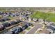 Expansive aerial view showcasing a residential neighborhood adjacent to a lush green golf course at 1868 Homestead Dr, Fort Lupton, CO 80621