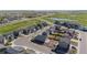 Aerial view of a neighborhood with manicured lawns and a golf course nearby at 1868 Homestead Dr, Fort Lupton, CO 80621