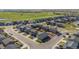 Aerial view of a neighborhood with a golf course and green space in the distance at 1868 Homestead Dr, Fort Lupton, CO 80621