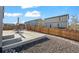 Backyard with concrete patio, gravel landscaping, and wooden fence at 1868 Homestead Dr, Fort Lupton, CO 80621