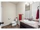 Neutral bathroom featuring a sink with granite top, tile flooring, and a toilet at 1868 Homestead Dr, Fort Lupton, CO 80621