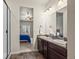 Bright bathroom features double sinks, dark wood cabinets, and walk-in shower at 1868 Homestead Dr, Fort Lupton, CO 80621