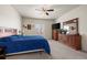 A bedroom with a queen bed, dresser, nightstand, and a window at 1868 Homestead Dr, Fort Lupton, CO 80621