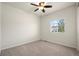 Cozy bedroom features carpet, a ceiling fan, and a bright window at 1868 Homestead Dr, Fort Lupton, CO 80621