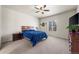 A cozy bedroom with a comfortable bed, a nightstand, and a window with blinds at 1868 Homestead Dr, Fort Lupton, CO 80621