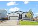 Charming single-story home with a well-manicured lawn and attached two-car garage at 1868 Homestead Dr, Fort Lupton, CO 80621
