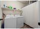 Functional laundry room with a washer, dryer, and storage shelves at 1868 Homestead Dr, Fort Lupton, CO 80621