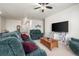 A comfortable living room with large sofas, a coffee table, and a modern TV stand at 1868 Homestead Dr, Fort Lupton, CO 80621