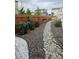 Yard with gravel landscaping, rocks, and small leafy plants at 1868 Homestead Dr, Fort Lupton, CO 80621