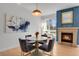 Charming dining room with marble table, fireplace, and bright window, creating an inviting atmosphere at 2500 E Cherry Creek South Dr # 116, Denver, CO 80209