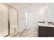 Modern bathroom featuring a glass-enclosed shower, stylish vanity, and attractive tile flooring at 647 Nightsky St, Erie, CO 80516