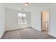 Bright bedroom featuring a window and neutral carpet, creating a warm and inviting space at 647 Nightsky St, Erie, CO 80516