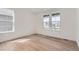 Bright bedroom with hardwood floors and large windows offering neighborhood views at 647 Nightsky St, Erie, CO 80516