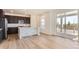 Modern kitchen featuring dark cabinets, white countertops, stainless steel appliances, and an eat in island at 647 Nightsky St, Erie, CO 80516