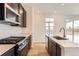 Kitchen with white countertops, stainless steel appliances and a gas range at 647 Nightsky St, Erie, CO 80516