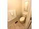 A cozy half bath with a white toilet, neutral-colored wall and flooring and a towel rack at 4996 S Gibraltar Way, Centennial, CO 80015