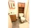 Bathroom with single sink, toilet, and shelving unit at 4996 S Gibraltar Way, Centennial, CO 80015