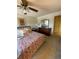 Bedroom featuring a floral bedspread, ceiling fan, dresser, and carpeted floor at 4996 S Gibraltar Way, Centennial, CO 80015