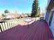 Outdoor deck with a glass table, offering a view of the surrounding neighborhood and backyard at 4996 S Gibraltar Way, Centennial, CO 80015