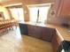 An eat-in kitchen with wood cabinets, and a large window over the sink that looks into the dining area at 4996 S Gibraltar Way, Centennial, CO 80015