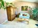 Living room with a light-colored sofa, wood furniture, and plants at 4996 S Gibraltar Way, Centennial, CO 80015