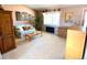 Living room with a light-colored sofa, wood furniture, and a large window at 4996 S Gibraltar Way, Centennial, CO 80015