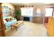 Living room with a light-colored sofa, wood furniture, and a large window at 4996 S Gibraltar Way, Centennial, CO 80015