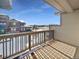 Balcony with wooden railing, offering a view of the neighborhood during the winter at 591 Brennan Cir, Erie, CO 80516