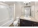 Well-lit bathroom featuring a shower-tub combo, modern vanity, and neutral finishes at 591 Brennan Cir, Erie, CO 80516