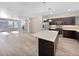 Open-concept kitchen with stainless steel appliances, quartz counters, a breakfast bar and fireplace at 591 Brennan Cir, Erie, CO 80516