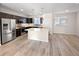 Modern kitchen featuring stainless steel appliances, a large island, and a breakfast bar at 591 Brennan Cir, Erie, CO 80516