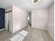 This airy living room has hardwood floors, neutral walls, and a barn door bathroom at 591 Brennan Cir, Erie, CO 80516