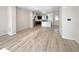 Open-concept living space showcasing hardwood floors and connecting to the kitchen at 591 Brennan Cir, Erie, CO 80516