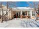 Spacious backyard with a patio and snow-covered lawn at 3016 Greensborough Dr, Highlands Ranch, CO 80129