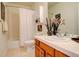 Clean bathroom with a shower/tub combo and wood vanity at 3016 Greensborough Dr, Highlands Ranch, CO 80129