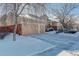 Two-story home with attached garage and snow-covered landscaping at 3016 Greensborough Dr, Highlands Ranch, CO 80129