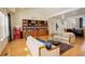 Bright living room featuring hardwood floors, built-in shelving, and comfortable seating at 3016 Greensborough Dr, Highlands Ranch, CO 80129