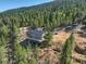Aerial shot of the home highlighting the deck and the surrounding landscape at 33884 Bergen View Trl, Evergreen, CO 80439