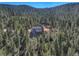 Aerial view of the home nestled in a forest, highlighting its secluded location and natural surroundings at 33884 Bergen View Trl, Evergreen, CO 80439