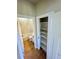 Bright bathroom features a marble-tiled shower, adjacent to a storage closet with shelving at 33884 Bergen View Trl, Evergreen, CO 80439