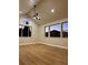 Bright room with vaulted ceiling, ceiling fan, hardwood flooring, and mountain views at 33884 Bergen View Trl, Evergreen, CO 80439