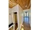 Inviting entryway featuring a wood plank ceiling, coat closet, and hardwood floors at 33884 Bergen View Trl, Evergreen, CO 80439