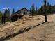 Modern home on a hill, complete with wrap around porch overlooking the hillside at 33884 Bergen View Trl, Evergreen, CO 80439