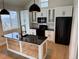 Modern kitchen features sleek black appliances, granite countertops, and custom wood paneling at 33884 Bergen View Trl, Evergreen, CO 80439