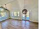 Sun-filled living room with vaulted ceilings, modern fan, and a large window with scenic views at 33884 Bergen View Trl, Evergreen, CO 80439