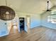 Bright living room with vaulted ceiling, ceiling fan, and a modern stacked washer and dryer at 33884 Bergen View Trl, Evergreen, CO 80439