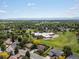 Expansive aerial shot featuring community school and green neighborhood with mountain views in the distance at 7055 E Heritage S Pl, Centennial, CO 80111