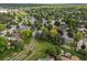 Stunning aerial view of a lush, green neighborhood with mature trees and well-maintained homes at 7055 E Heritage S Pl, Centennial, CO 80111