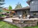 Outdoor space features a patio with a fire pit, dining, seating area, grill, and attractive landscaping at 7055 E Heritage S Pl, Centennial, CO 80111